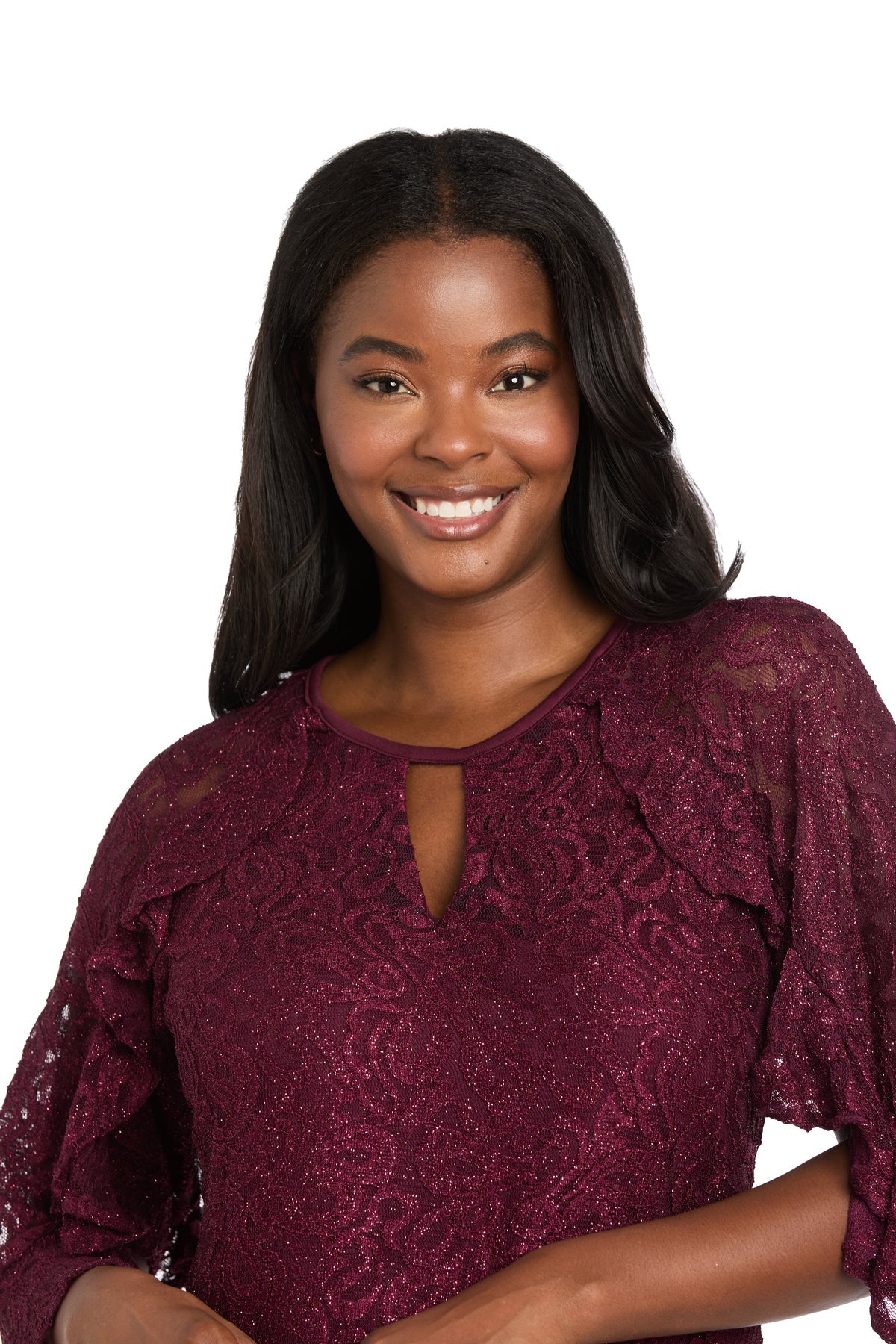 A woman with long dark hair smiles while wearing the R&M Richards 4226 short lace semi-formal dress, featuring an a-line silhouette, standing against a white background.
